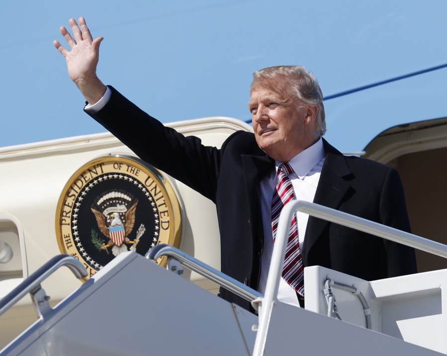 President Donald Trump waves Thursday, March 2, 2017, upon his arrival on Air Force One at Langley Air Force Base, Va. Trump will be visiting a private, religious school in Florida on Friday, signaling that his education agenda will focus on school choice.