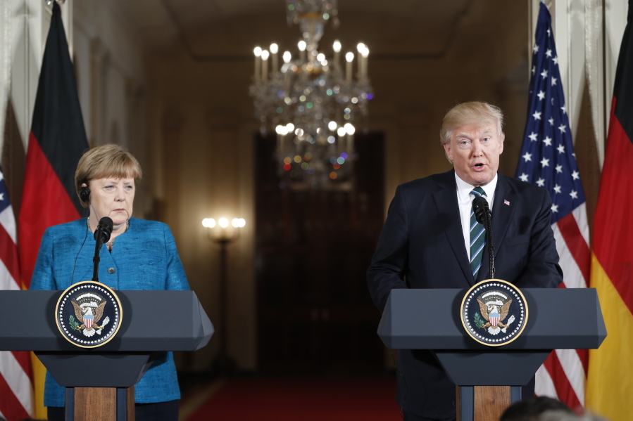 President Donald Trump and German Chancellor Angela Merkel participate in a joint news conference in the East Room of the White House in Washington Friday.