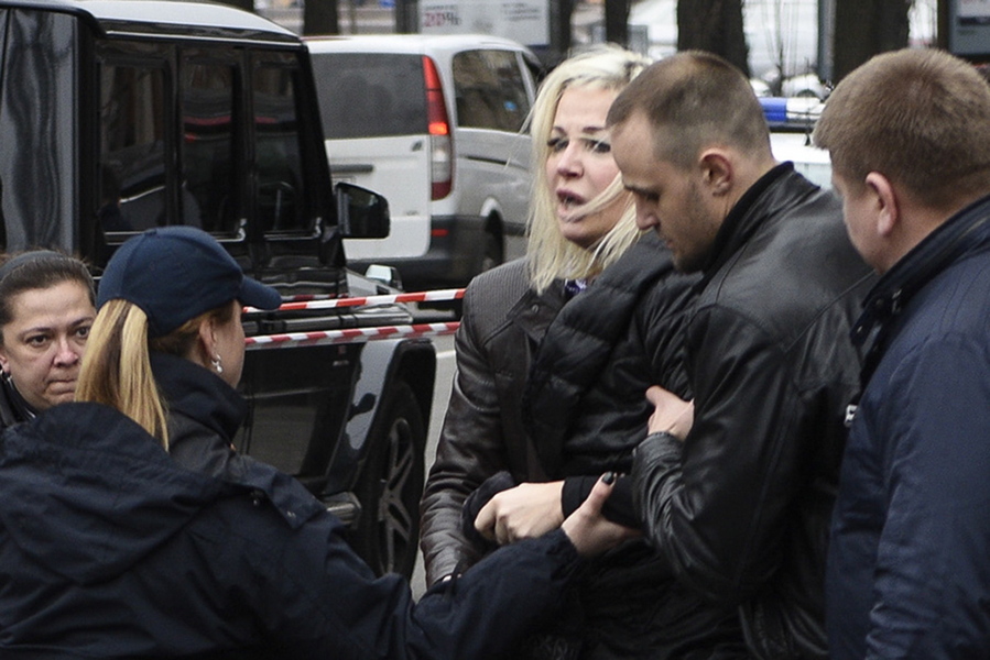 Maria Maksakova is assisted from the place where her husband Denis Voronenkov was killed, in Kiev, Ukraine, Thursday, March 23, 2017. Former Russian lawmaker Denis Voronenkov was shot and killed in Kiev Thursday in what the Ukrainian president described as an &quot;act of state terrorism&quot; by Russia, an accusation the Kremlin quickly rejected.
