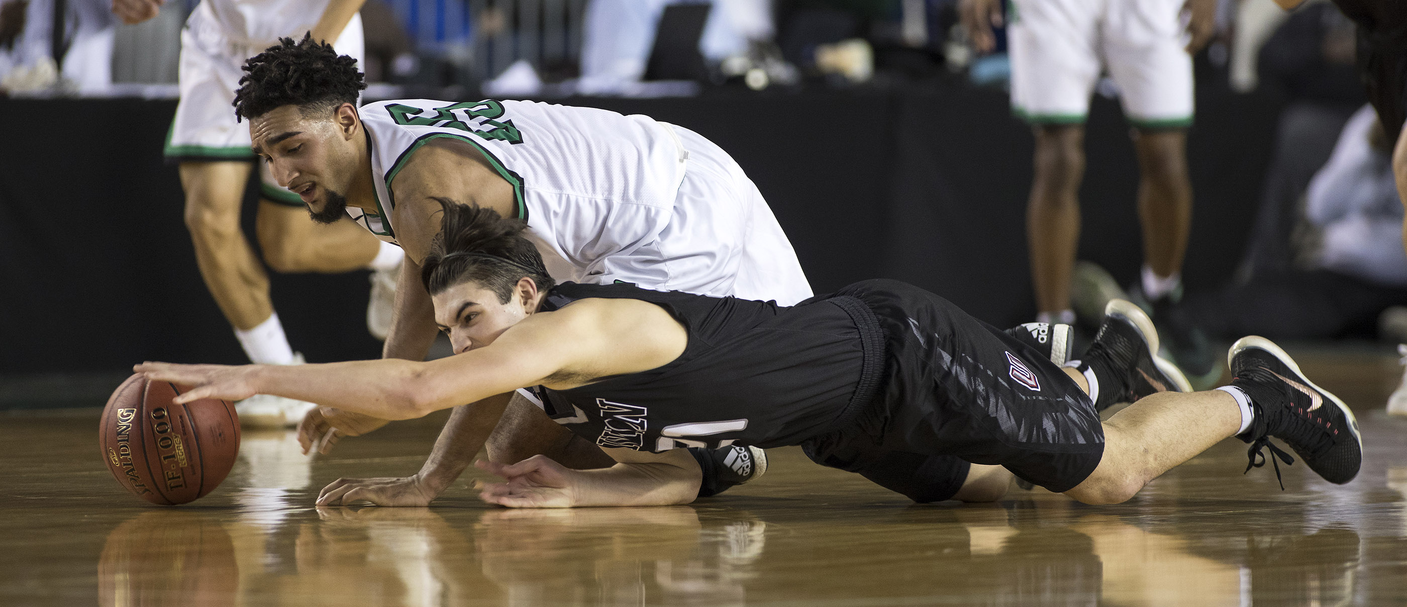 Union's Austin Lewis, below, fights for a loose ball with Kentwood's Darius Lubom Saturday, March 4, 2017, during the 4A Boys State Basketball Tournament Championship game in Tacoma, Wash. Union lost 81-61 to take seconnd place.