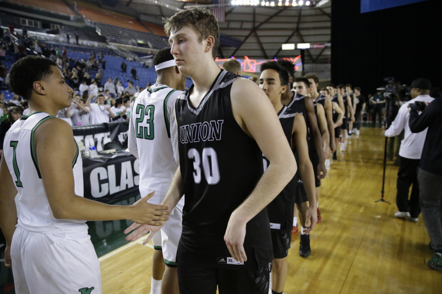 Union guard Cameron Cranston (30) greets Kentwood players after Kentwood won the boys&#039; Class 4A high school basketball championship game Saturday, March 4, 2017, in Tacoma, Wash. (AP Photo/Ted S.