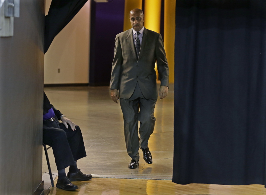 FILE - In this Jan. 18, 2017 file photo, Washington coach Lorenzo Romar walks past a curtain as he heads to the court for the team&#039;s NCAA college basketball game against Colorado in Seattle. Washington announced Wednesday, March 15, 2017, that Romar had been fired after 15 seasons at the school. (AP Photo/Ted S.