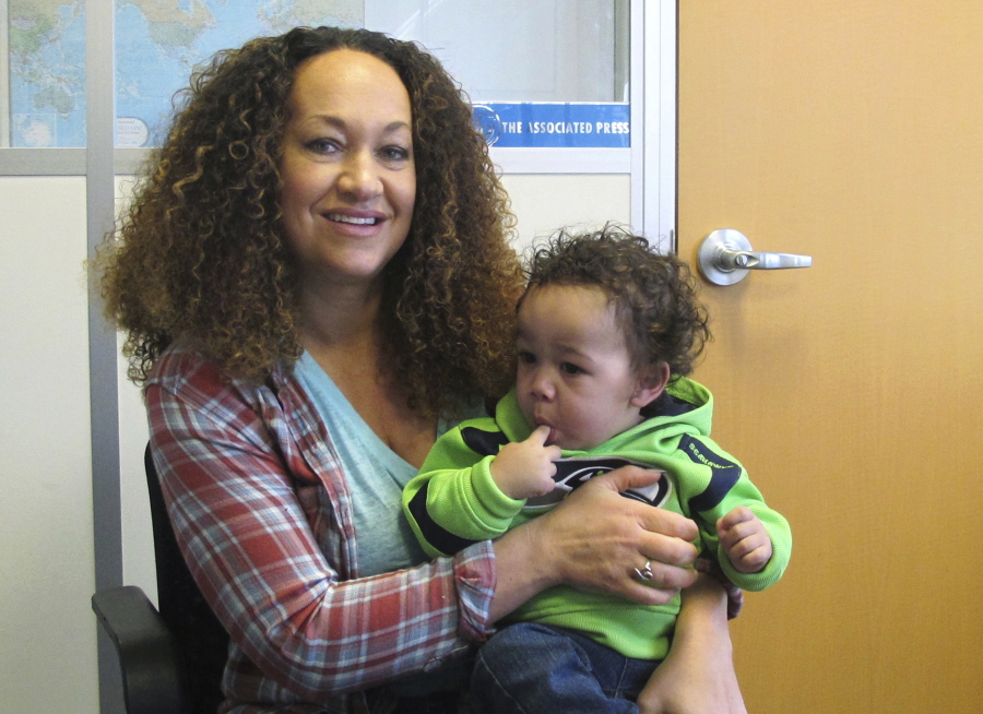Rachel Dolezal poses for a photo with her son, Langston, in the bureau of the Associated Press in Spokane Monday. Dolezal lost her job when her parents exposed her as being white and is now struggling to make a living. (Nicholas K.