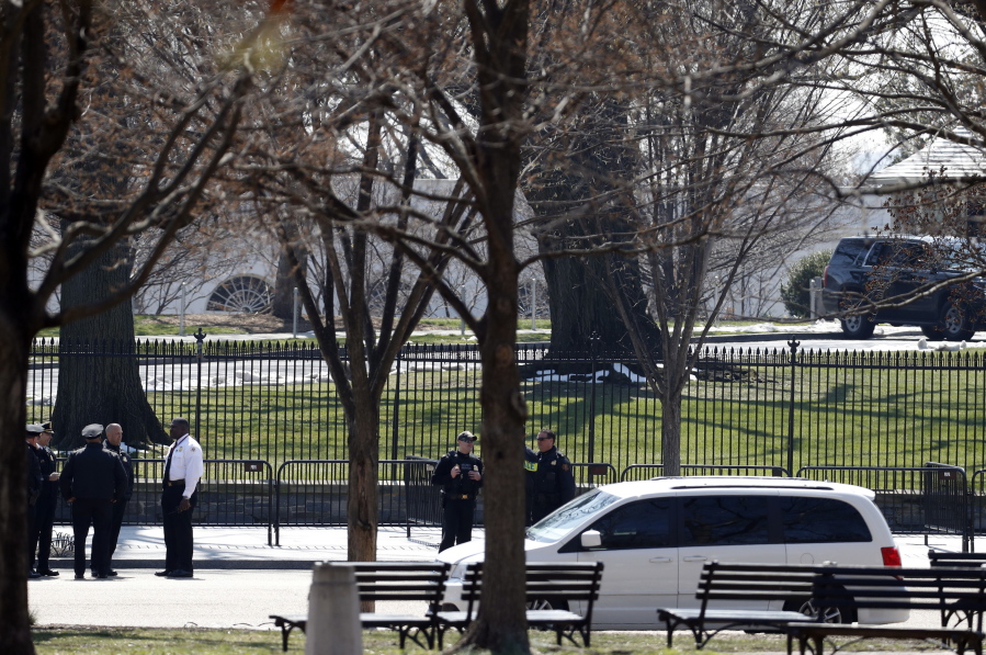 U.S. Secret Service officers stand in the cordoned off area on Pennsylvania Avenue after a security incident near the fence of the White House in Washington on Saturday.