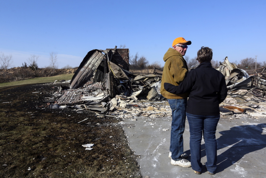 Jeff Jackson and his wife, Zane, share a moment as they view their destroyed home in the Highlands subdivision on Wednesday, March 8, 2017, in Hutchinson, Kan. The home was destroyed in the wildfires Monday night. Wednesday was their first time viewing the damage.