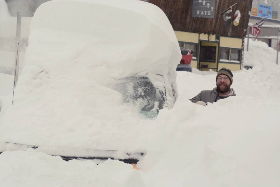 Surrounded by neck-deep snow, Scott Young tries to dig out his van early Wednesday in a parking lot in Saranac Lake, N.Y. The area received up to 40 inches of snow in Tuesday&#039;s storm.