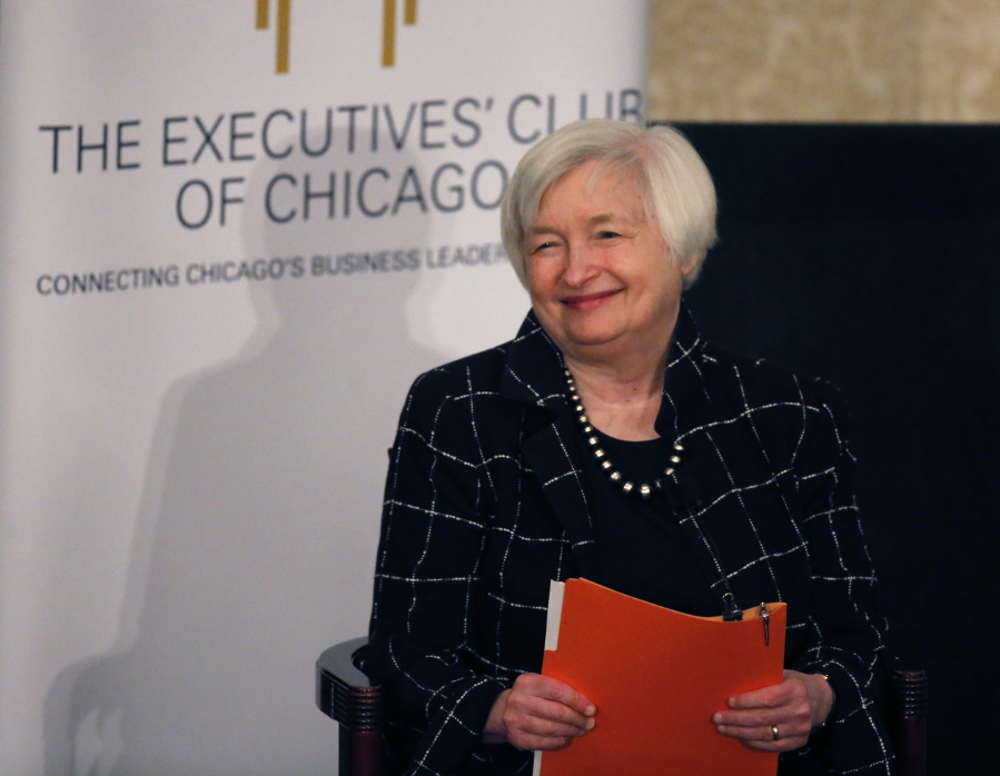 Federal Reserve Chair Janet Yellen listens to her introduction Friday before addressing the Executives&#039; Club of Chicago. Yellen signaled that the Fed will likely resume raising interest rates later this month.