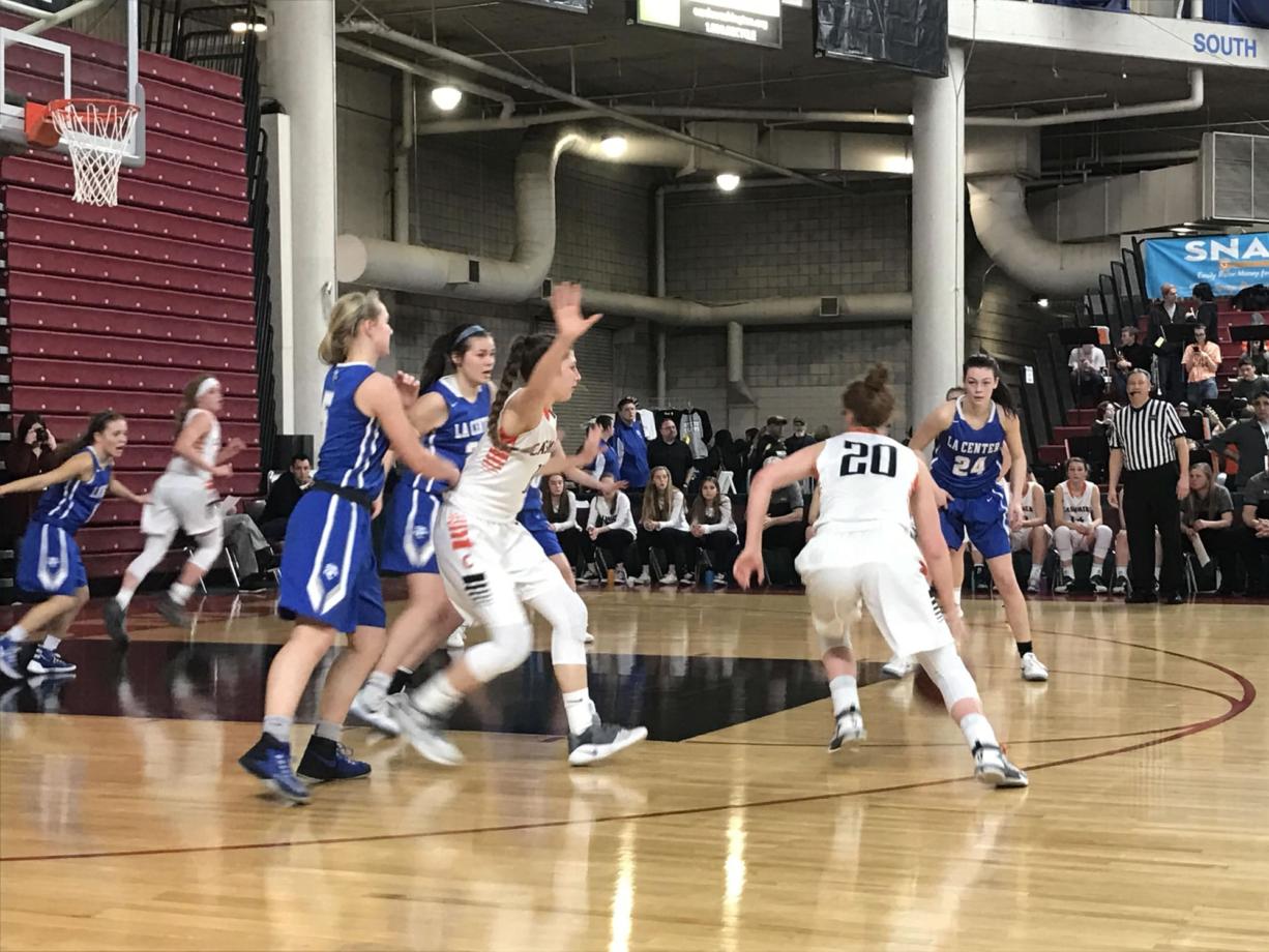 La Center's defense begins to converge on Cashmere's Cami Knishka (20) during Thursday's Class 1A girls quarterfinal at the Yakima Valley SunDome. The top-ranked and undefeated Bulldogs won, 60-28.
