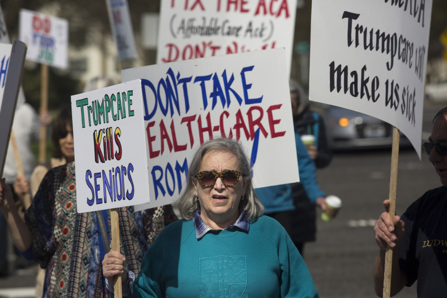 Geri Baer waves a sign reading &quot;Trumpcare Kills Seniors&quot; at a recent rally in Clark County. Several different Indivisible chapters coordinated their efforts and spread across Clark County, waving signs to show support for the Affordable Care Act.