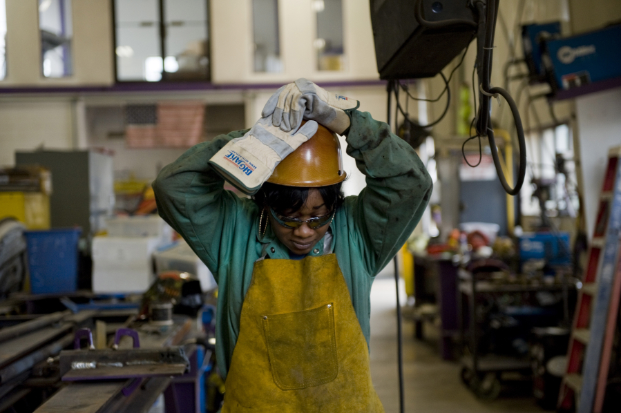Journeywoman ironworker Bridget Booker dons her hard hat on a job site in East Peoria, Ill., on April 19.