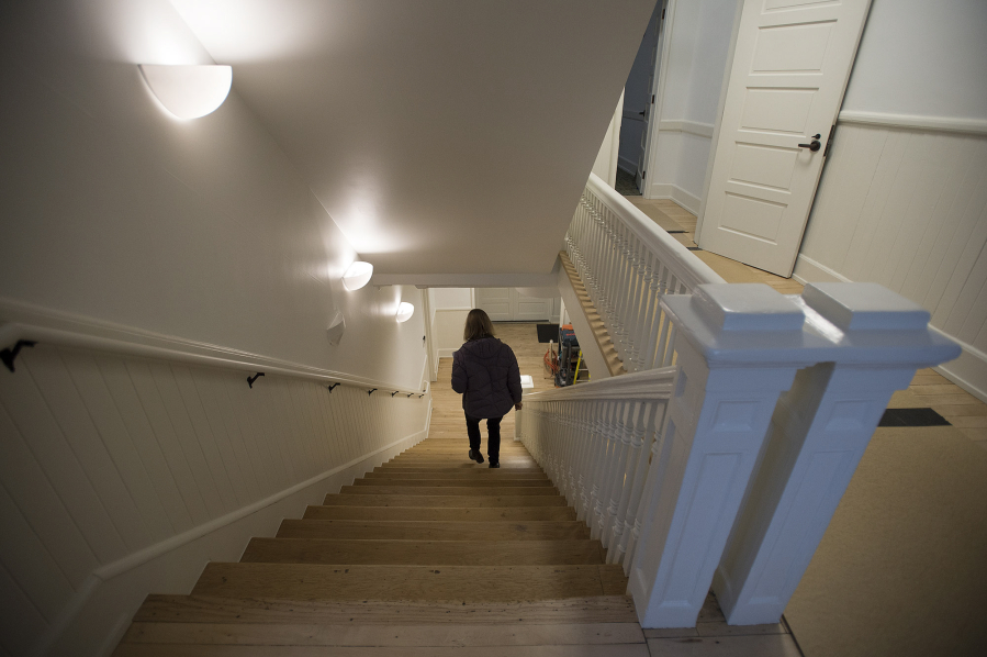 Public affairs officer Sue Ripp descends a staircase at Fort Vancouver National Historic Site after the Gifford Pinchot National Forest moved into the Vancouver Barracks building in January.