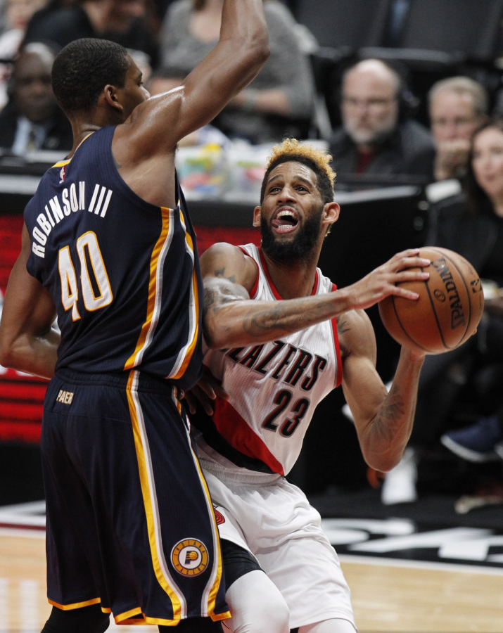 Portland Trail Blazers guard Allen Crabbe, right, shoots as Indiana Pacers guard Glenn Robinson III defends during the second half of an NBA basketball game in Portland, Ore., Wednesday, Nov. 30, 2016. Portland won 131-109.