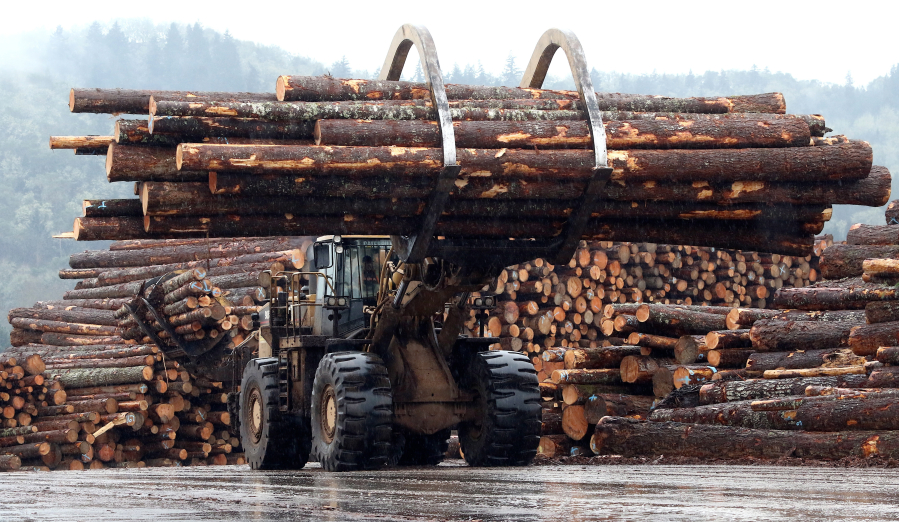 A front end log loader transports logs in 2015 at Swanson Group Manufacturing in Roseburg, Ore. The 20 percent duty on Canadian softwood lumber imports may be a boon for the Oregon lumber industry.