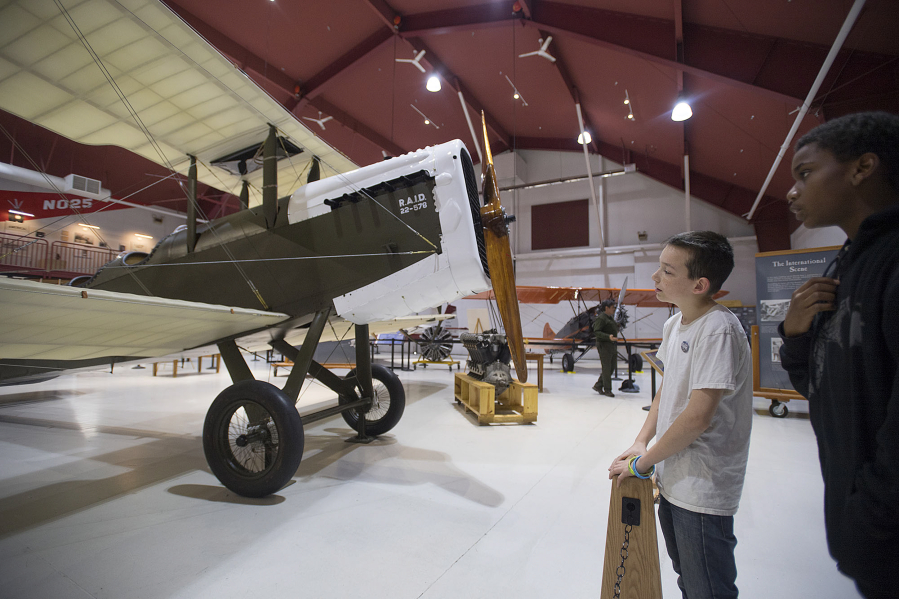 Josh Repp, 12, of Portland, left, and friend Jamar Snead, 11, check out the DH-4 Liberty biplane at Pearson Air Museum. The museum will be part of the Council on America&#039;s Military Past&#039;s tour Thursday.
