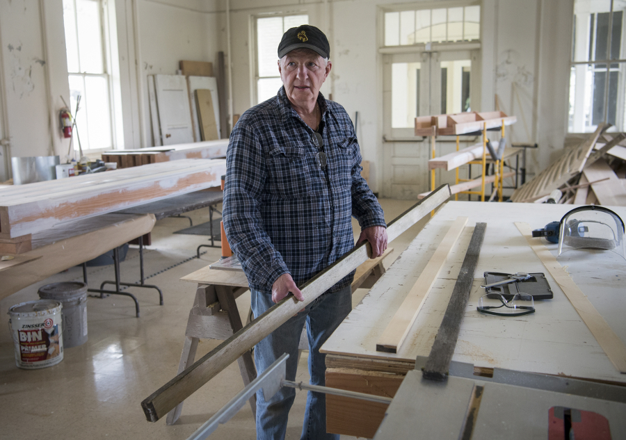 Jim Bunzey, in the Fort Vancouver National Trust workshop, prepares a length of salvaged cedar to be used to renovate a weathered park bench.