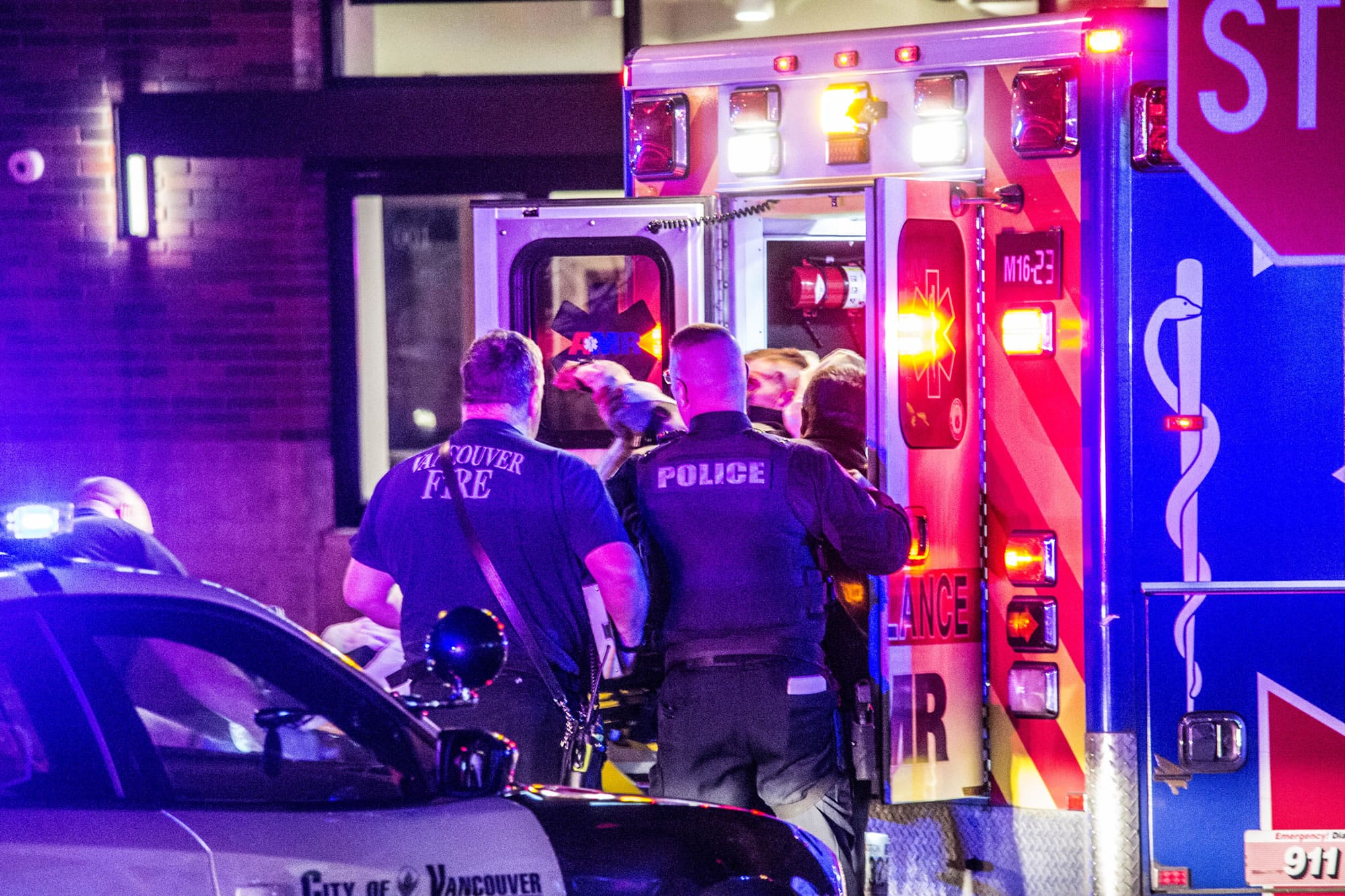 A Vancouver police officer is loaded into an ambulance after sustaining injuries during an altercation with an alleged aggressive panhandler Friday night near the corners of Sixth and Main streets in downtown Vancouver. The officer, who has not been identified, was treated at a local hospital and released, according to Vancouver police.
