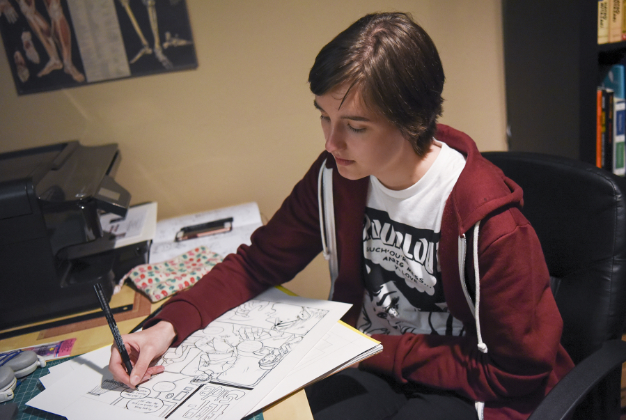 Ridgefield High School student Tatum Howlett works on a comic from her desk at her home in Battle Ground.
