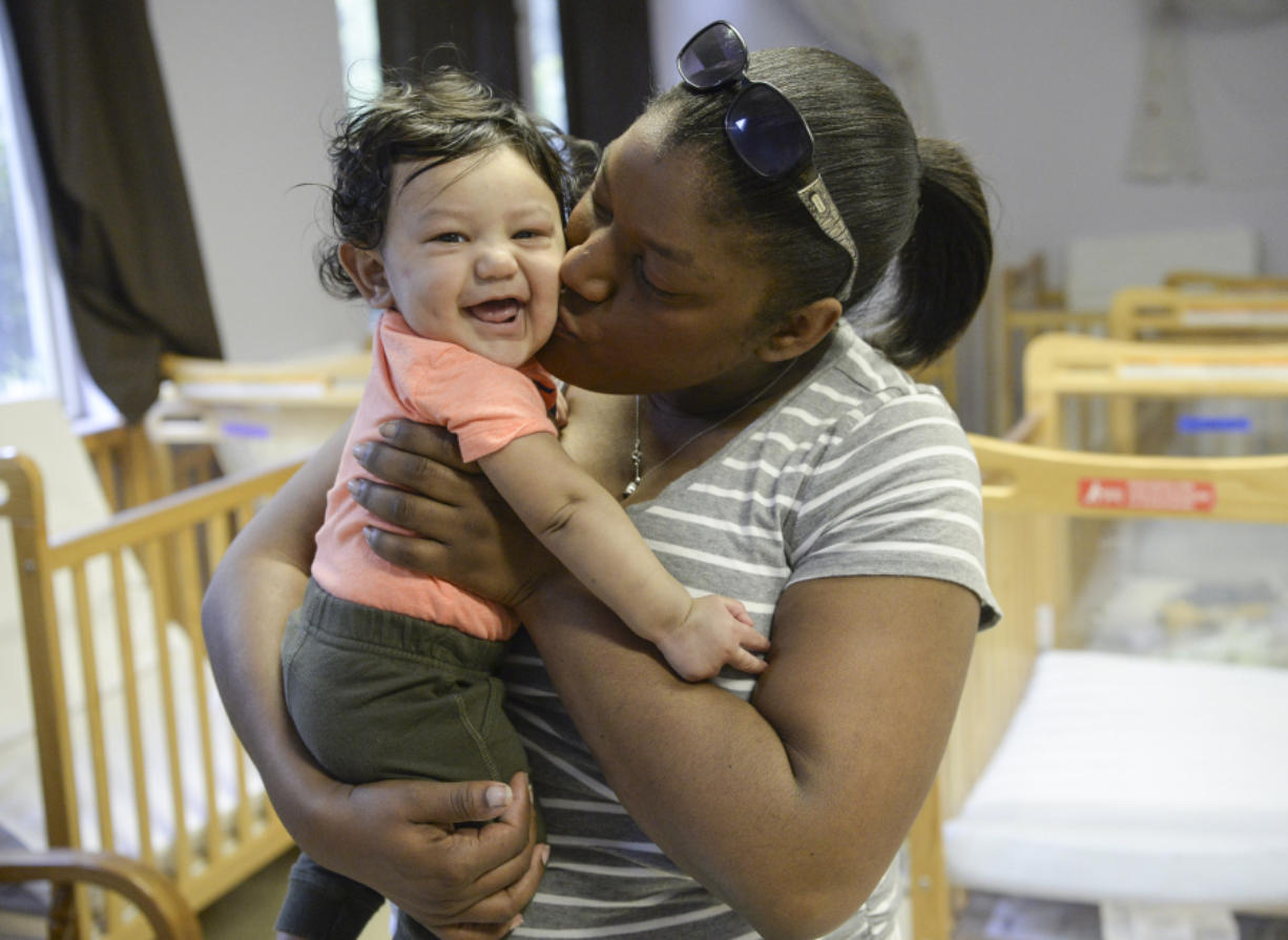 Marlene Julye kisses her son, 6-month-old Asher Peeks, before leaving him at the YMCA Springfield Meadows YMCA Child Development Center on Monday.