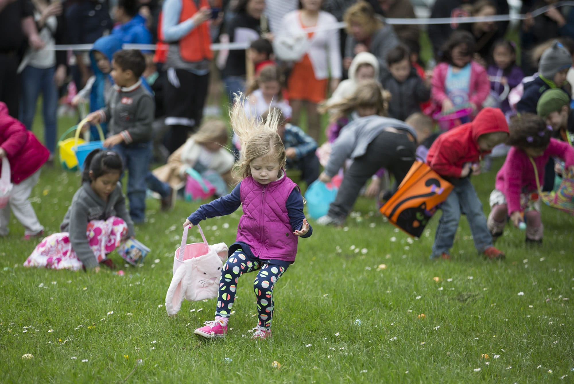 Four- and five-year-olds scramble at the start of the annual Easter egg hunt in Camas' Crown Park on Sunday. The hunt offered more than 14,000 eggs for different age groups to grab up. Photo by Randy L.
