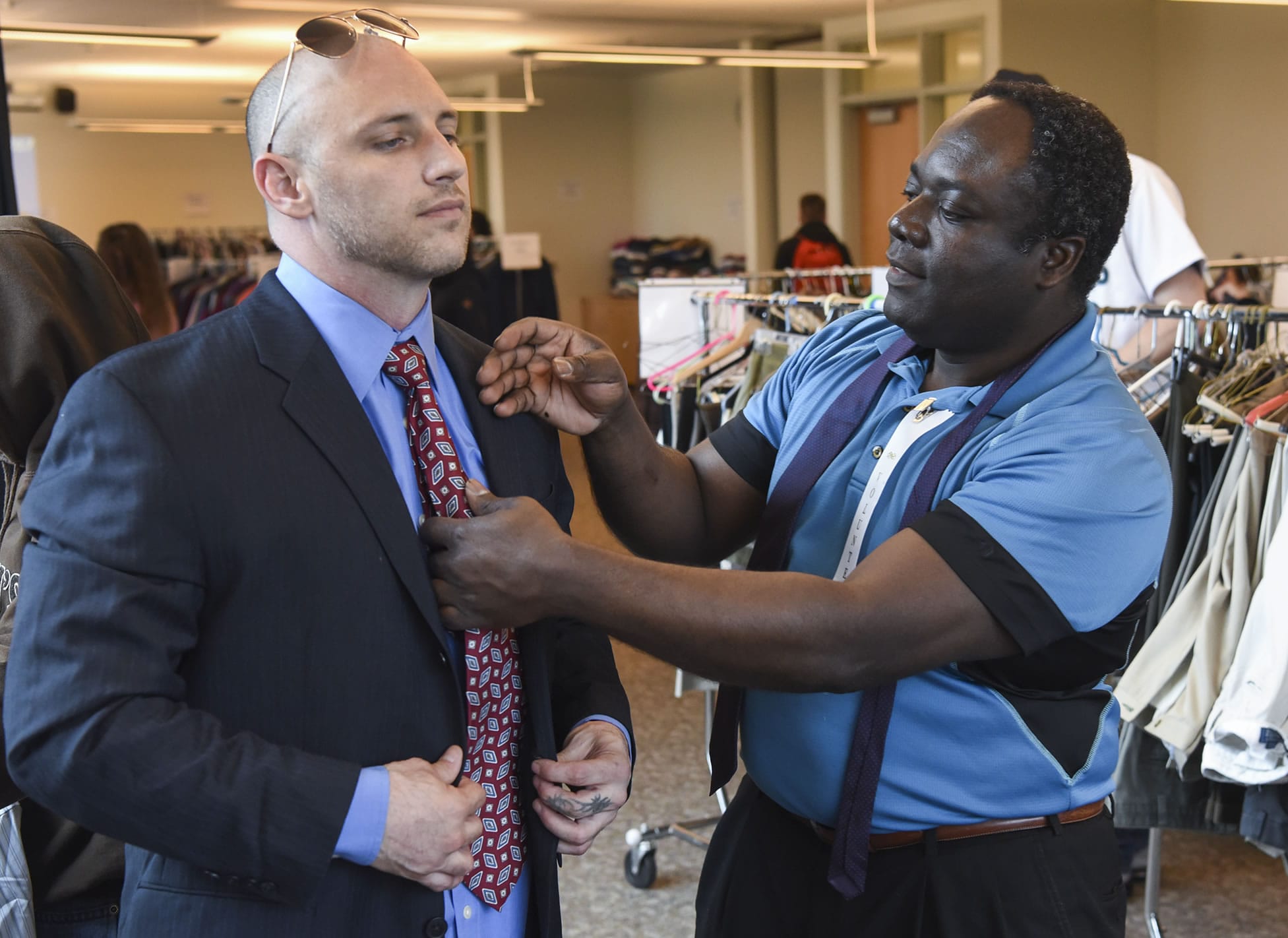 Nick Ak, a Career Clothing Closet volunteer, right, helps Clark College student George Esser with his necktie at the college’s Career Clothing Closet on Wednesday.