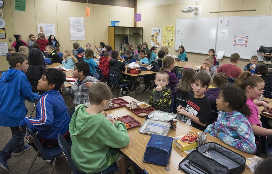 Third-graders eat lunch in a crowded classroom at Pleasant Valley Primary. The southern part of the Battle Ground school district faces growth as hundreds of homes are slated for construction and sale in the coming months.