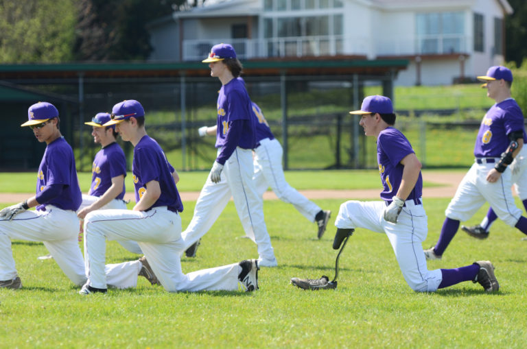 Daren Manheimer, second from right, stretches with his team before a game at Columbia River High School. &quot;He&#039;s just like us,&quot; said teammate Jacob Barnes.