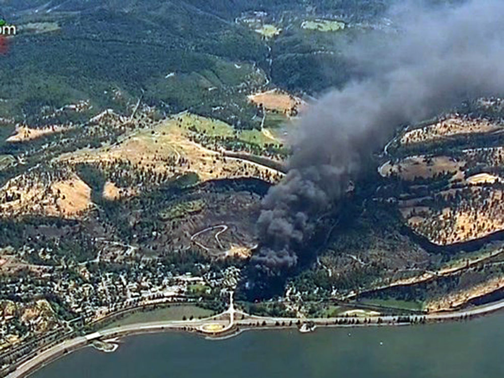 FILE - In this June 3, 2016, file image made from a video provided by KGW-TV, smoke billows from a Union Pacific train that derailed near Mosier, Ore., in the scenic Columbia River Gorge. Inspectors have found almost 24,000 safety defects over a two-year period along United States railroad routes used to ship volatile crude oil. Data obtained by The Associated Press shows many of the defects were similar to problems blamed in past derailments that caused massive fires or oil spills in Oregon, Virginia and Montana.