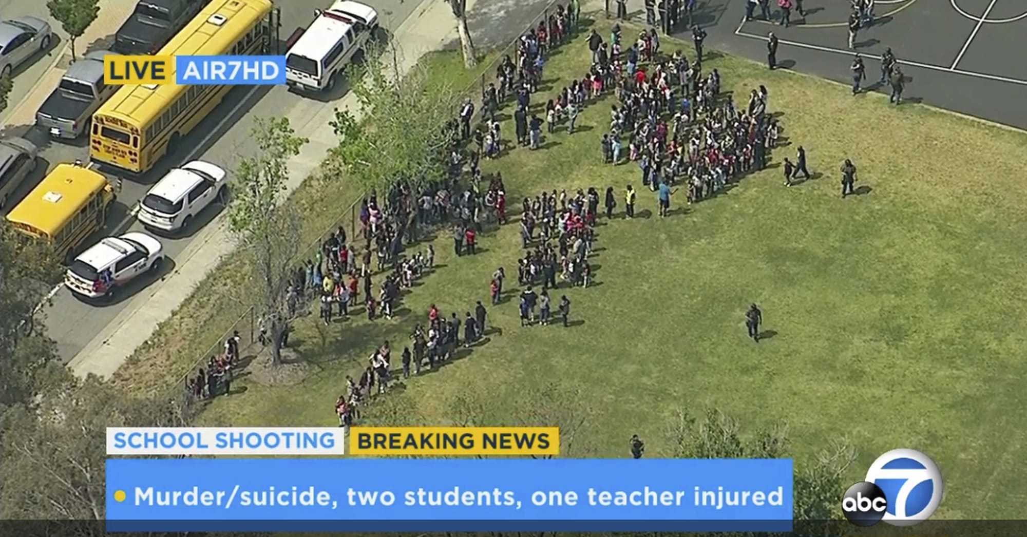 In this frame from video provided by KABC-TV, faculty and students evacuate North Park School Elementary School as emergency personnel respond to a shooting inside on Monday, April 10, 2017, in San Bernardino, Calif.