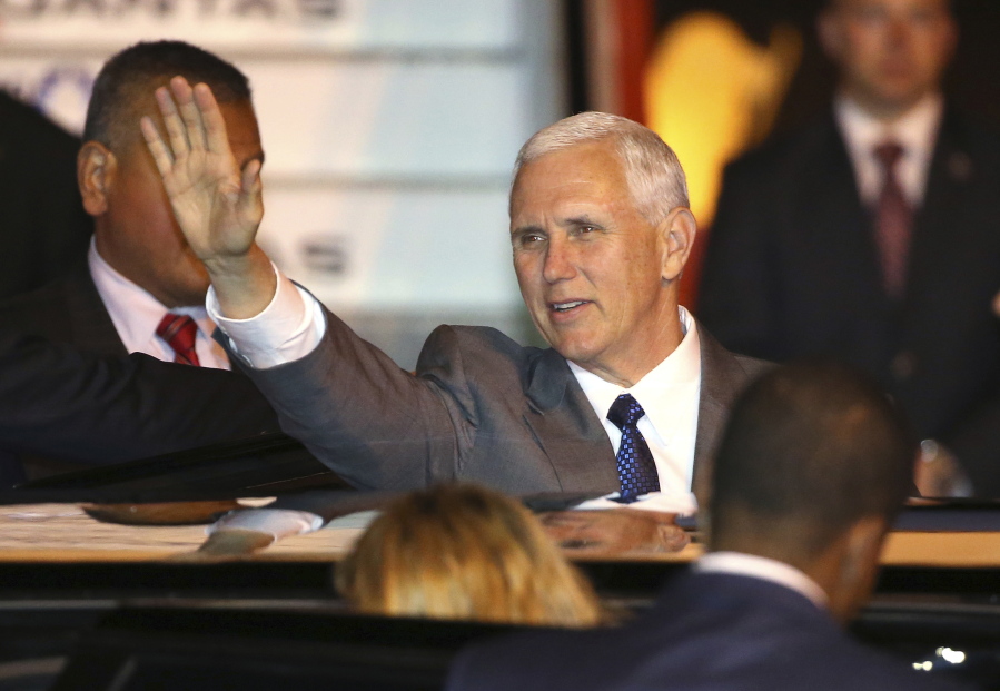 U.S. Vice President Mike Pence waves as he gets into his car after arriving in Sydney, Friday, April 21, 2017. Pence will meet with Australian Prime Minister Malcolm Turnbull on Saturday as part of his 10-day, four country trip to Asia.