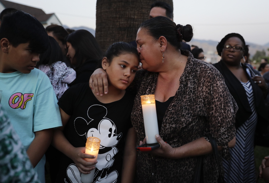 Betty Rodriguez, right, comforts her granddaughter Giselle during a prayer service held to honor the shooting victims at North Park Elementary School on Monday in San Bernardino, Calif. A man walked into his estranged wife&#039;s elementary school classroom in San Bernardino and opened fire on Monday. (AP Photo/Jae C.