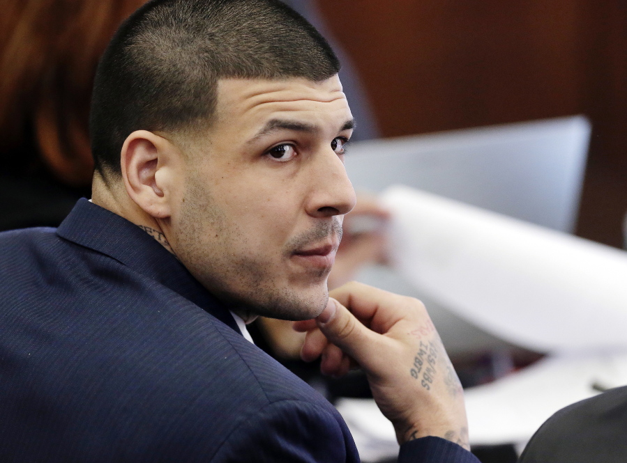 Aaron Hernandez listens March 15, 2017, during his double murder trial in Suffolk Superior Court, in Boston. Massachusetts prison officials said Hernandez hanged himself in his cell and pronounced dead at a hospital early Wednesday, April 19, 2017.