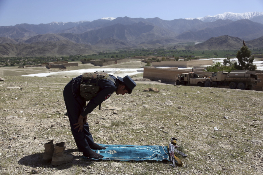 An Afghan security personnel prays in Pandola village near the site of a U.S. bombing in the Achin district of Jalalabad, east of Kabul, Afghanistan, on Friday. U.S. forces in Afghanistan on Thursday struck an Islamic State tunnel complex in eastern Afghanistan with the largest non-nuclear weapon every used in combat by the U.S. military, Pentagon officials said.