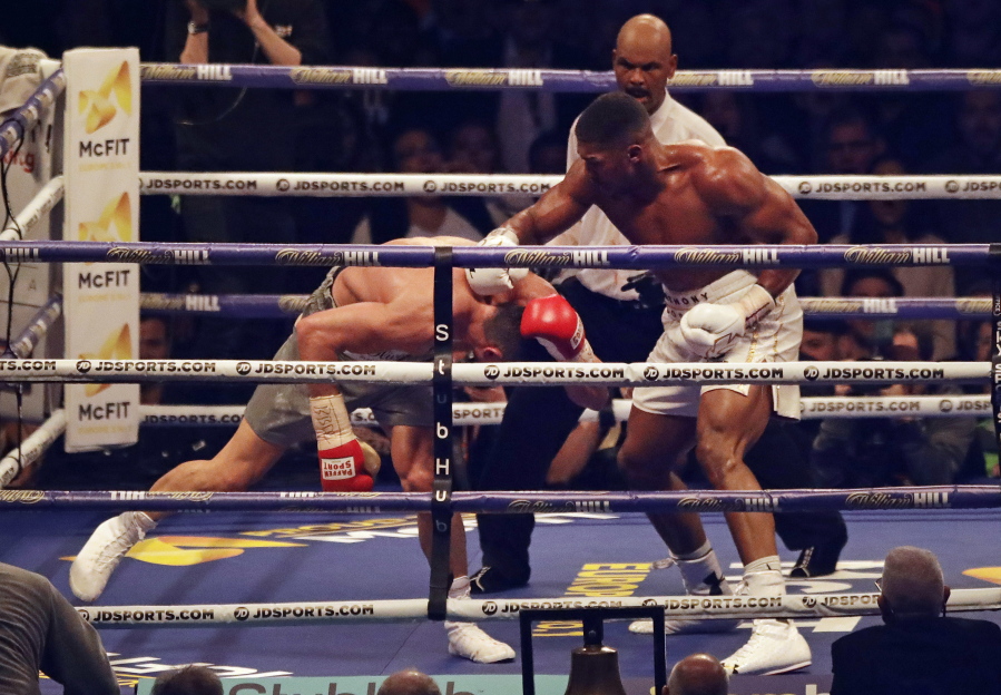 British boxer Anthony Joshua, right, knocks down Ukrainian boxer Wladimir Klitschko as they fight for Joshua&#039;s IBF and the vacant WBA Super World and IBO heavyweight titles at Wembley stadium in London, Saturday, April 29, 2017. Joshua won with an 11th round stoppage.