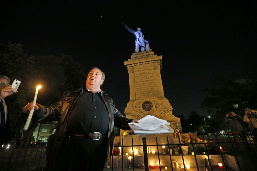 Charles Lincoln speaks during a candlelight vigil at the statue of Jefferson Davis in New Orleans, on Monday. New Orleans will begin taking down Confederate statutes, becoming the latest Southern body to divorce itself from what some say are symbols of racism and intolerance.
