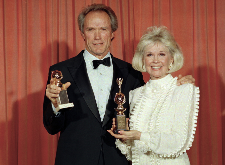 Clint Eastwood poses Jan. 29, 1989 with Doris Day at the 46th annual Golden Globe Awards in Beverly Hills, Calif. Eastwood won a Golden Globe for motion picture directing for his work on &quot;Bird,&quot; and Day was honored with the Cecil B. DeMille Award for her outstanding contribution to the film industry. The film and recording star Day is marking her birthday Monday, April 3, 2017, with a social media campaign to highlight her love of animals. (AP Photo/Douglas C.