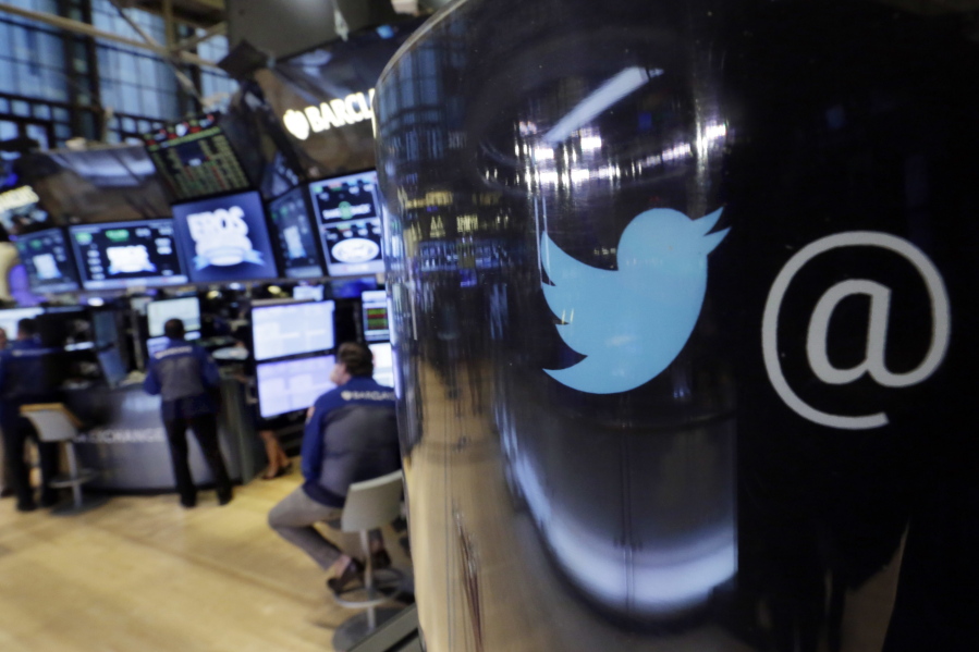 The Twitter logo appears on a phone post on the floor of the New York Stock Exchange.