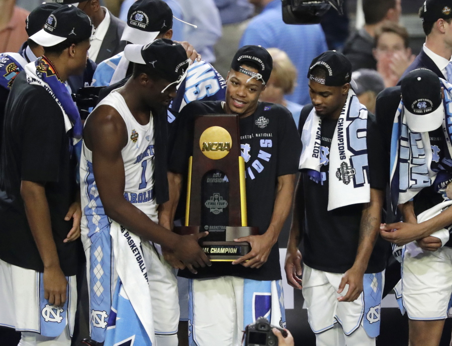 North Carolina players celebrate with the trophy after the championship game against Gonzaga at the Final Four NCAA college basketball tournament, Monday, April 3, 2017, in Glendale, Ariz. North Carolina 71-65.