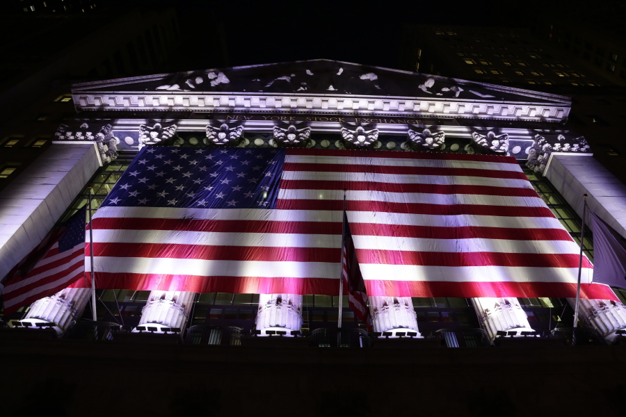 An American flag hangs on the front of the New York Stock Exchange. European stocks declined while most Asian markets rose Friday ahead of the first round of voting in France&#039;s closely watched presidential election.