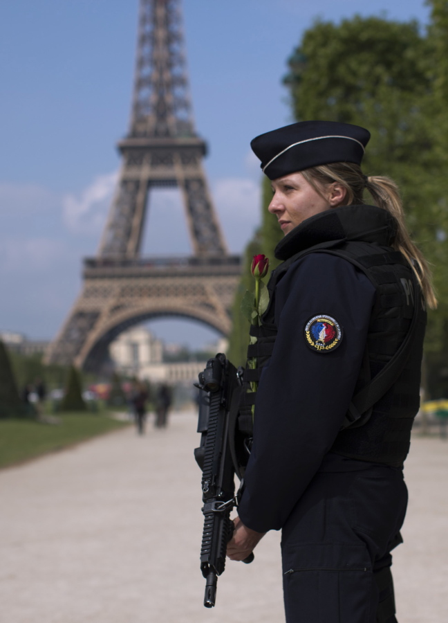 A French police officer patrols Saturday near the Eiffel Tower in Paris.
