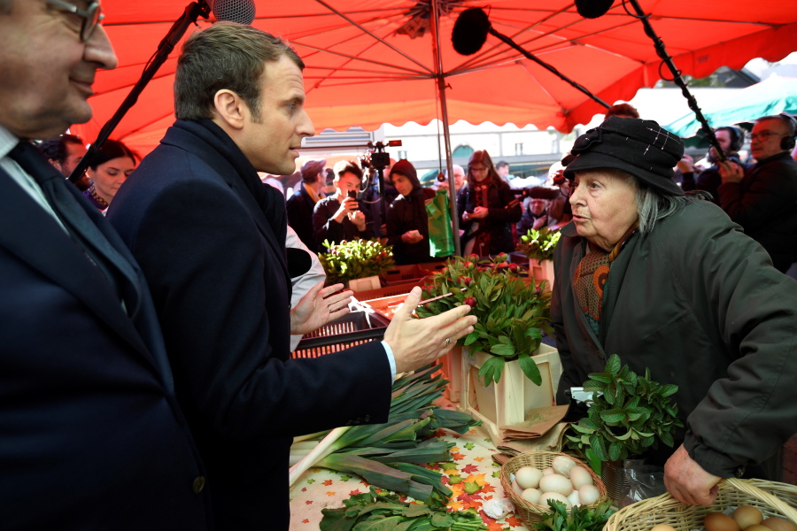 French centrist presidential candidate Emmanuel Macron visits a market Saturday in Poitiers, central France. Macron faces far-right presidential candidate Marine Le Pen in a May 7 runoff election.
