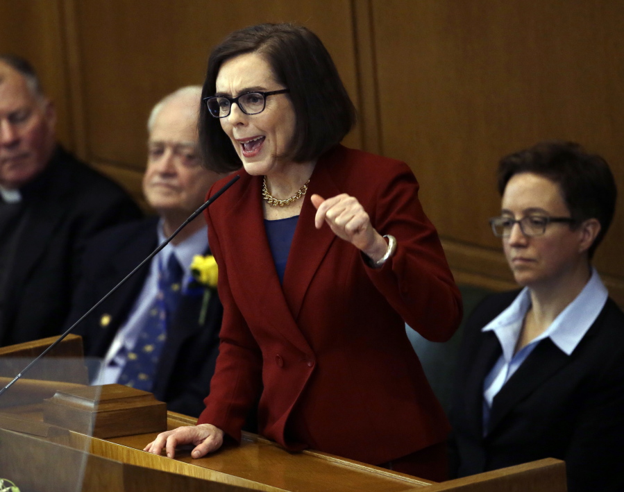 Oregon Gov. Kate Brown delivers her inaugural speech in the Capitol House chambers in Salem, Ore., in January. Brown has signed an executive order freezing the hiring of new state employees until the Oregon Legislature approves agency budgets for the upcoming biennium, which is currently facing a $1.6 billion shortfall.