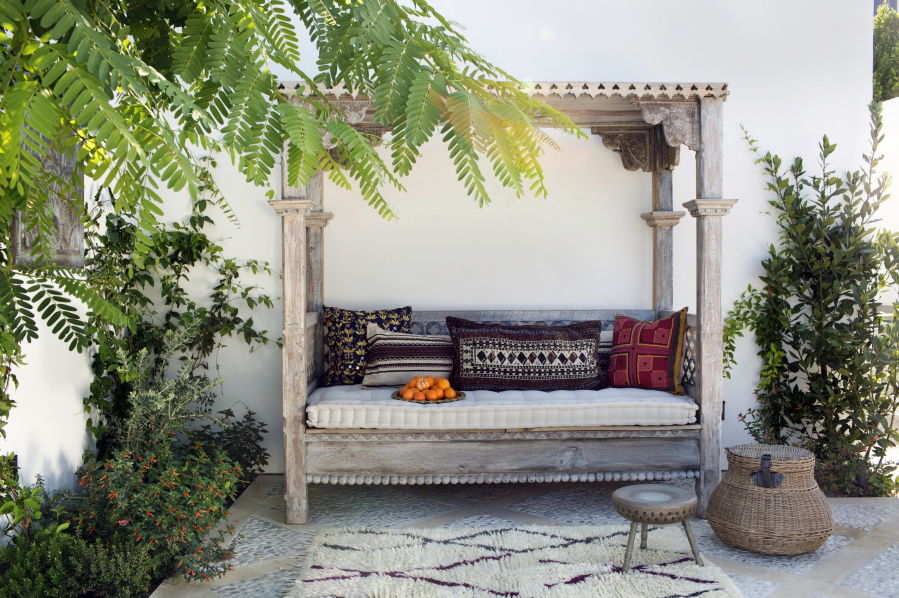 A rustic daybed on a patio in Los Angeles designed by Burnham of Burnham Design. As basic patio decorating has grown into the idea of creating an &quot;outdoor living room,&quot; seating options have come to include items like this rustic daybed.