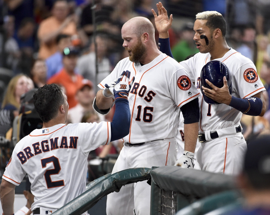 Houston Astros&#039; Brian McCann (16) celebrates his solo home run off Seattle Mariners starting pitcher Hisashi Iwakuma with Alex Bregman (2) and Carlos Correa, right, during the third inning of a baseball game, Tuesday, April 4, 2017, in Houston.