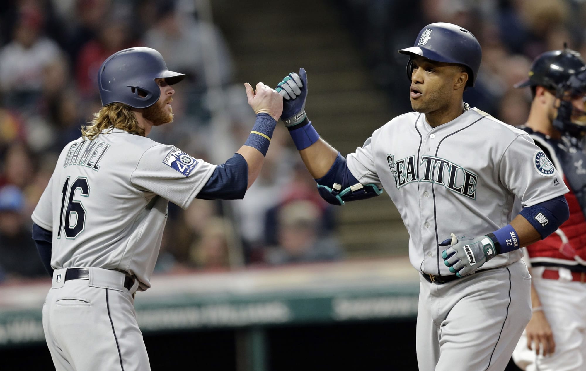 Seattle Mariners' Robinson Cano, right, is congratulated by Ben Gamel after Cano hit a two-run home run off Cleveland Indians starting pitcher Carlos Carrasco during the fourth inning of a baseball game, Friday, April 28, 2017, in Cleveland. Gamel scored on the play.