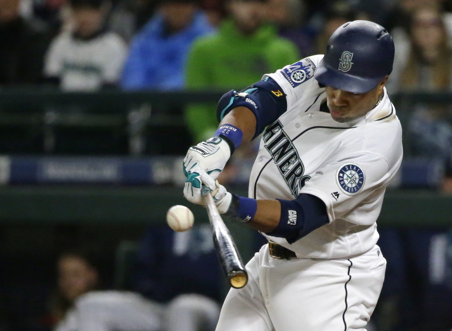 Robinson Cano hits a run-scoring double in the fourth inning against the Miami Marlins to score Jarrod Dyson on Monday. Cano was 2 for 4 with a first-inning home run as the Mariners won their fourth game in a row. (Ted S.