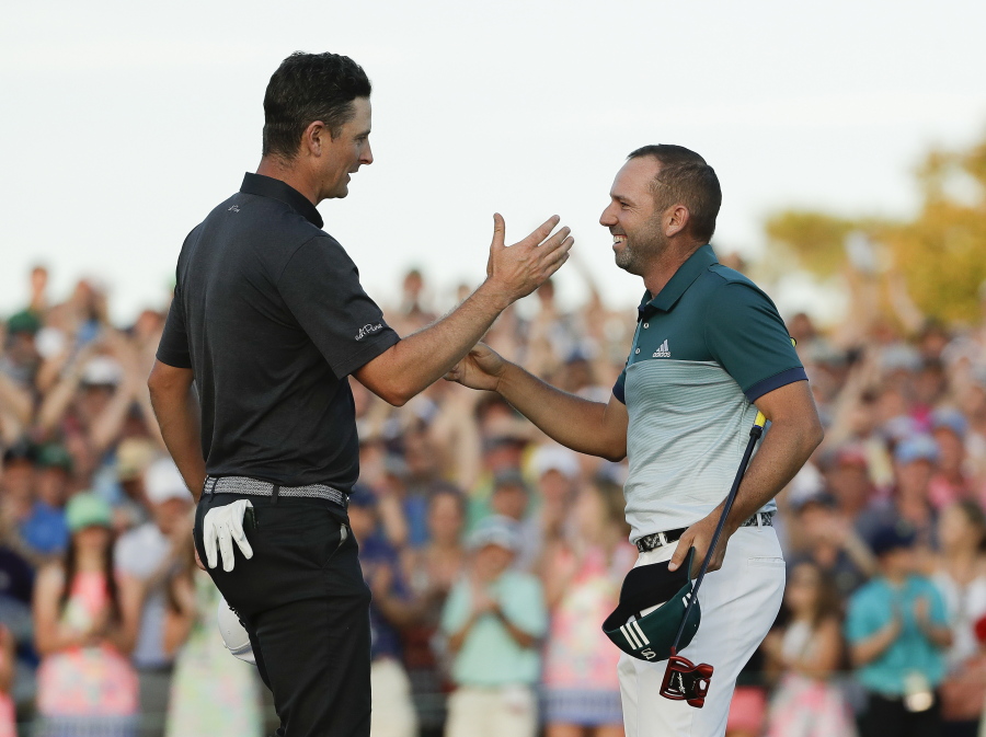 Sergio Garcia, of Spain, is congratulated by Justin Rose, of England, on the 18th hole after a playoff at the Masters golf tournament Sunday, April 9, 2017, in Augusta, Ga.