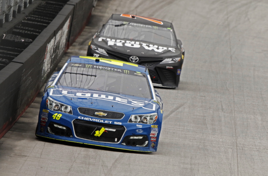 Driver Jimmie Johnson (48) leads driver Martin Truex Jr. (78) down the back stretch during a NASCAR Monster Energy NASCAR Cup Series auto race, Monday, April 24, 2017 in Bristol, Tenn.