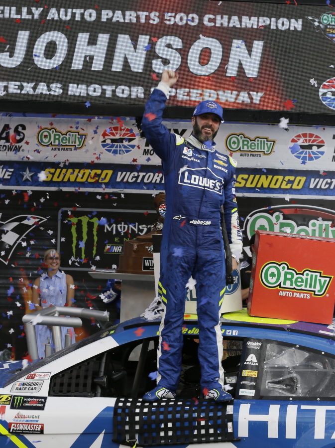 Jimmie Johnson celebrates in victory lane after winning the NASCAR Cup Series auto race at Texas Motor Speedway in Fort Worth, Texas, Sunday, April 9, 2017.