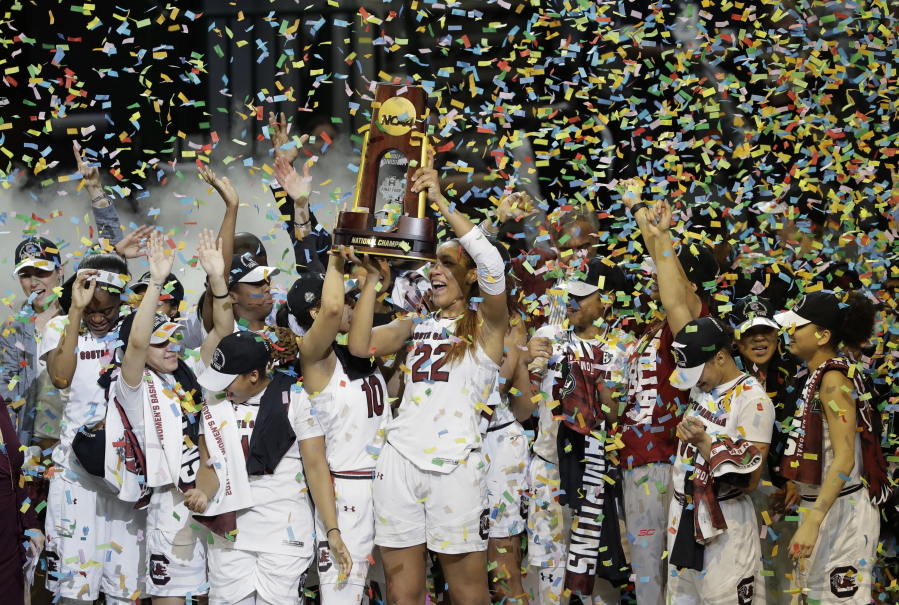 South Carolina forward A&#039;ja Wilson (22) holds the trophy as she and teammates celebrate their win over Mississippi State in the final of NCAA women&#039;s Final Four college basketball tournament, Sunday, April 2, 2017, in Dallas.