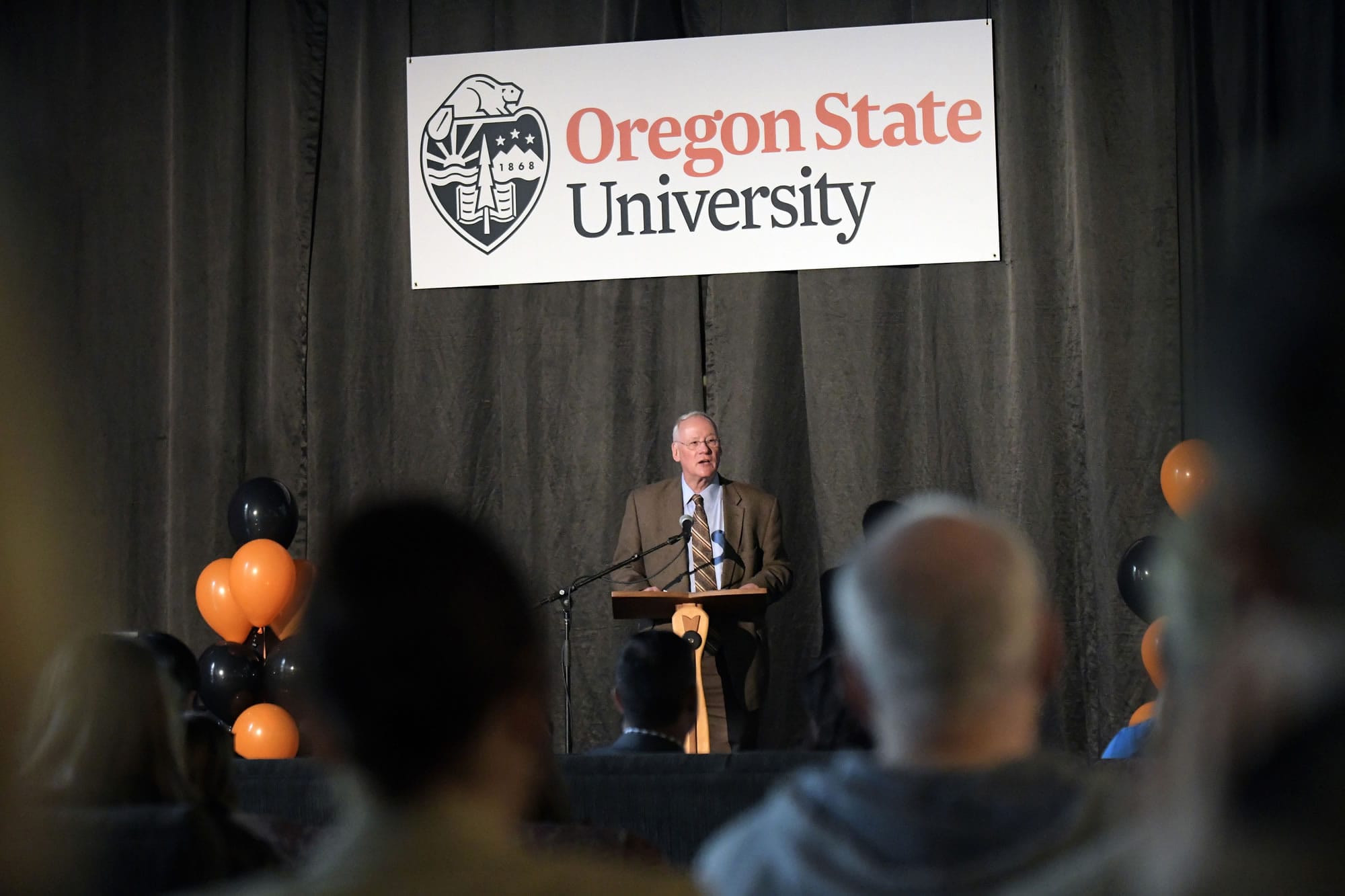 Oregon State University President Ed Ray unveils a new logo Monday in the Memorial Union in Corvallis, Ore.  The university unveiled a new logo in an effort to make the school stand out in Oregon and around the world.